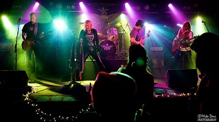 Photo effect showing the band performing live onstage.